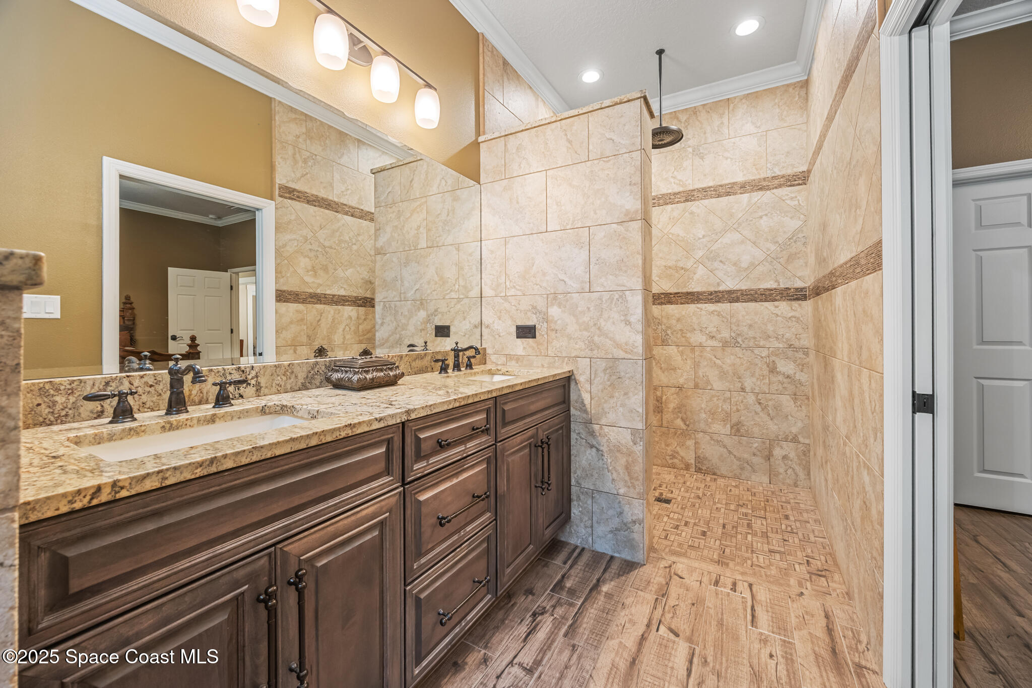 5495 Pine Street Cocoa, FL 32927 - Photo 21 of 45 a bathroom with a double vanity sink a mirror and a shower