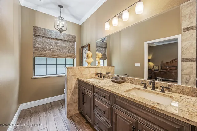 a bathroom with a granite countertop sink a large mirror and vanity