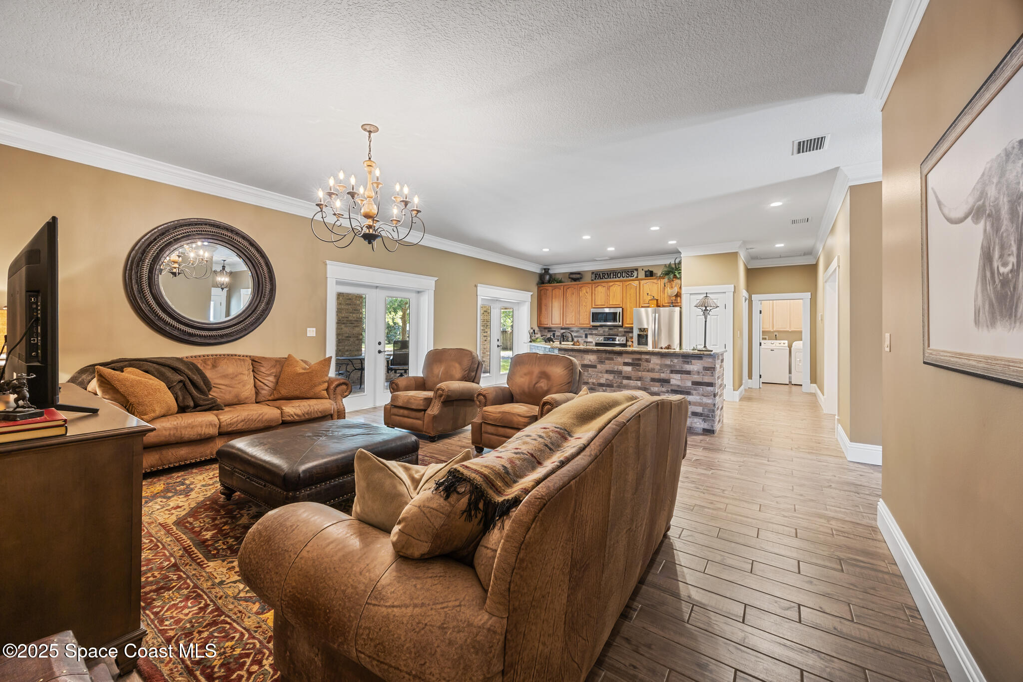 5495 Pine Street Cocoa, FL 32927 - Photo 24 of 45 a living room with furniture a clock and a large window