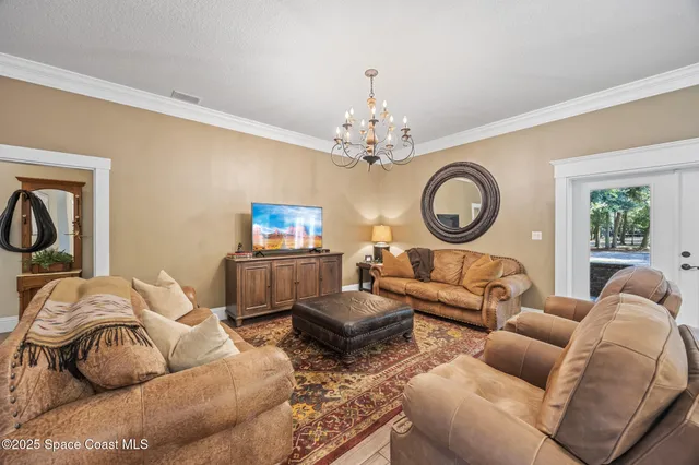 a living room with furniture a clock and a window