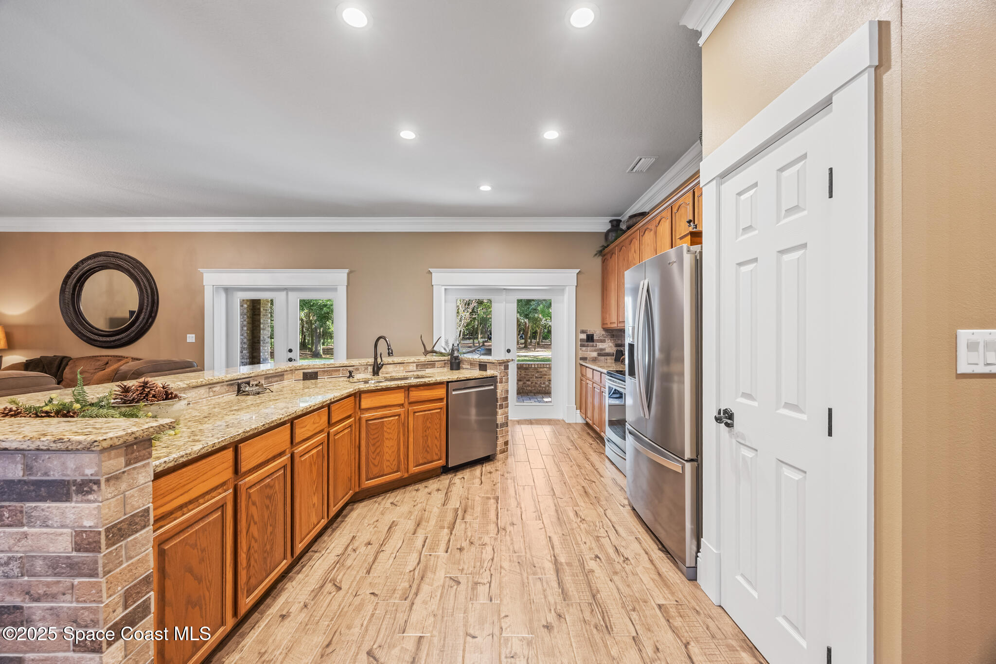 5495 Pine Street Cocoa, FL 32927 - Photo 27 of 45 a large kitchen with a lot of counter space and wooden floor