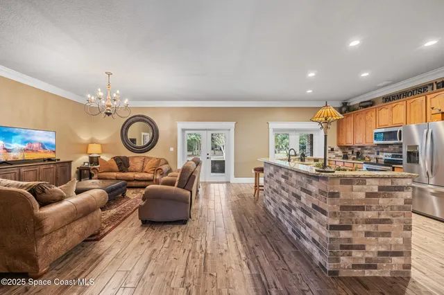 a living room with furniture a fireplace and a large window