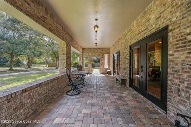 a view of a porch with chairs and backyard