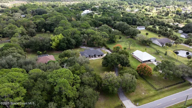 an aerial view of residential house with outdoor space and swimming pool