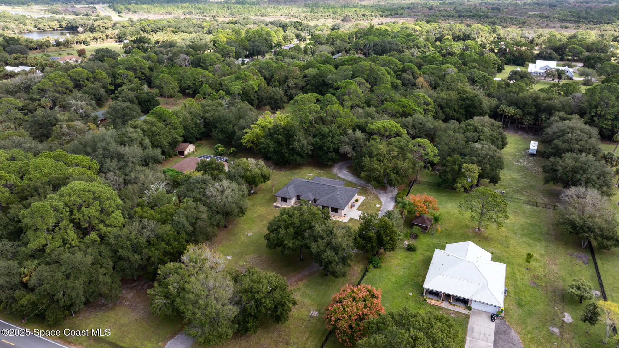 5495 Pine Street Cocoa, FL 32927 - Photo 43 of 45 an aerial view of a house with a yard and lake view