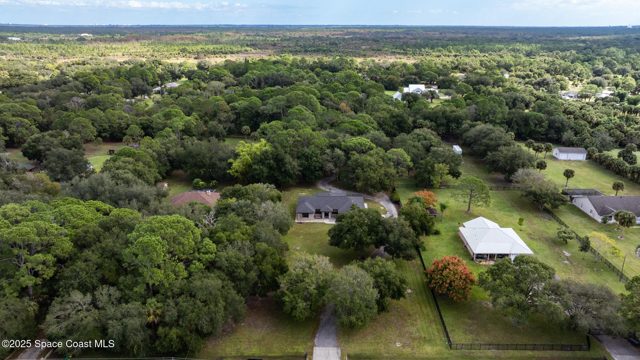 5495 Pine Street Cocoa, FL 32927 - Photo 44 of 45 an aerial view of a house with a yard and lake view