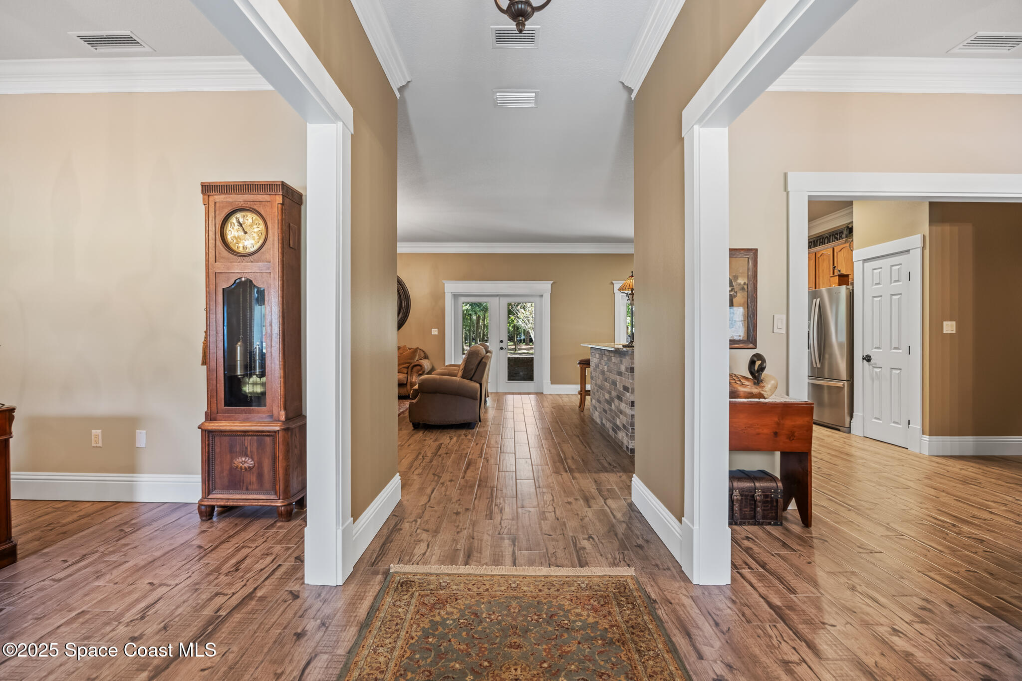 5495 Pine Street Cocoa, FL 32927 - Photo 10 of 45 a view of a hallway view with wooden floor and furniture