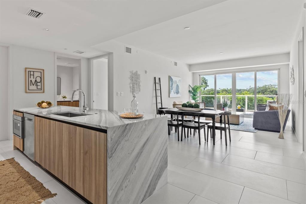 a dining room with furniture and a floor to ceiling window