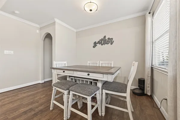a view of a dining room with furniture and wooden floor