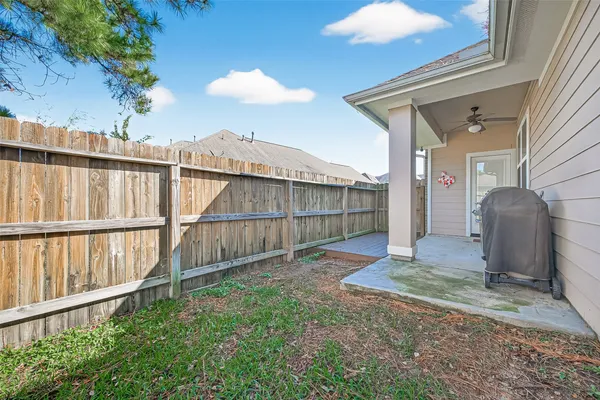 a view of a house with a yard and wooden fence