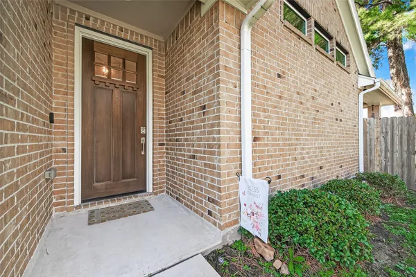 a view of a door and brick wall