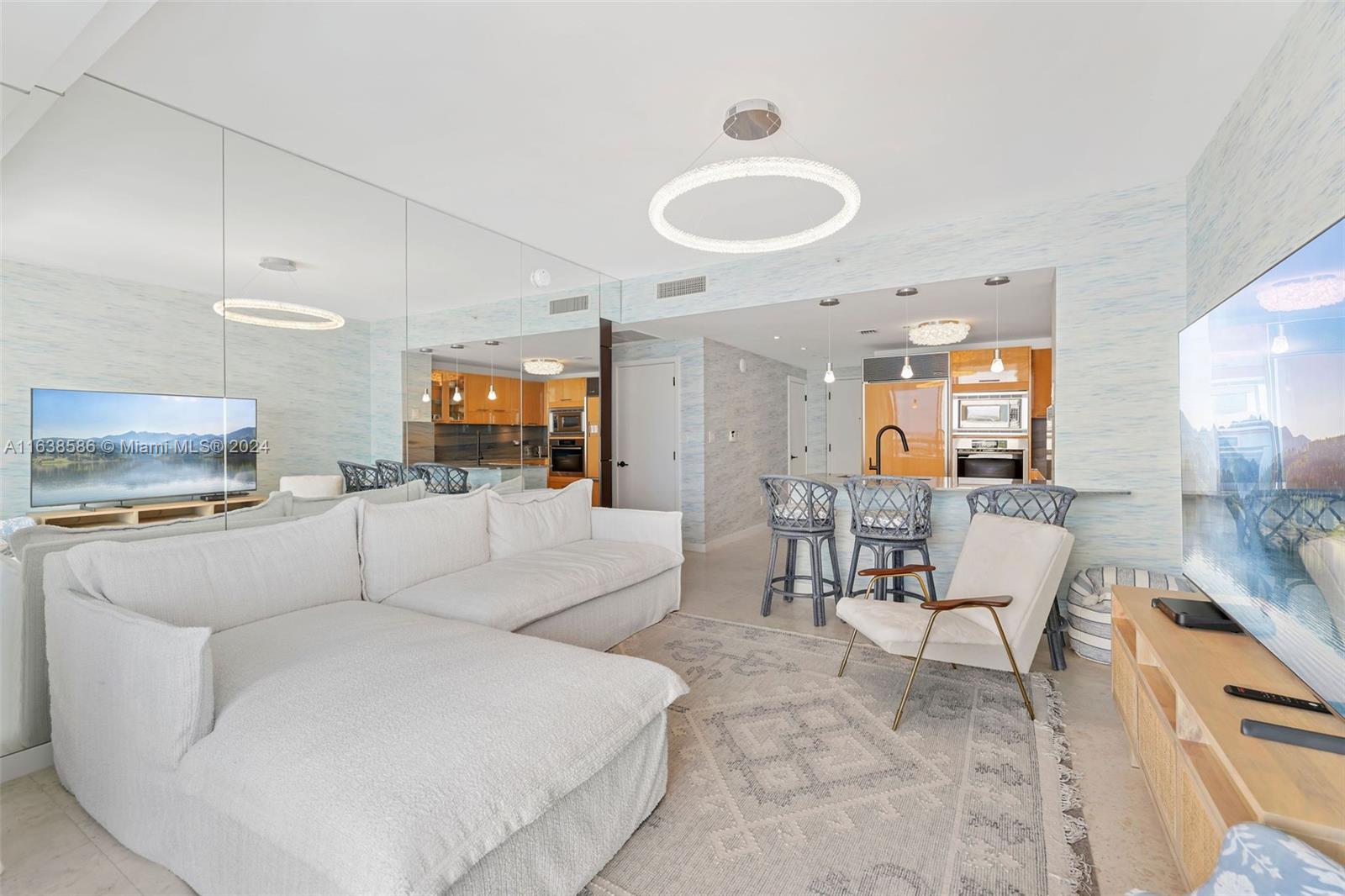 6799 Collins Avenue, Unit 1601 Miami Beach, FL 33141 - Photo 11 of 64 a living room with furniture and a dining table