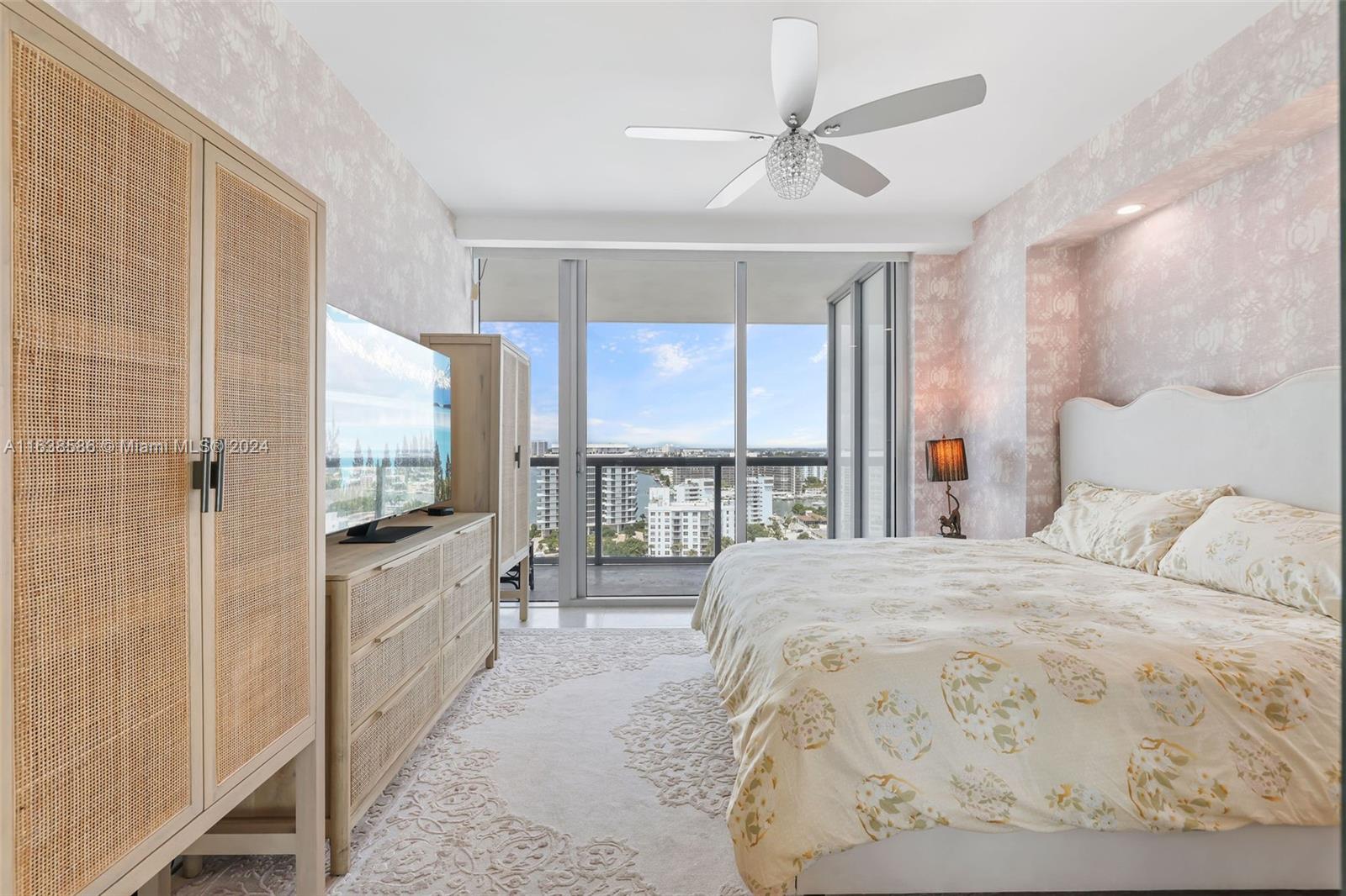 6799 Collins Avenue, Unit 1601 Miami Beach, FL 33141 - Photo 17 of 64 a large bedroom with a large bed and a flat screen tv