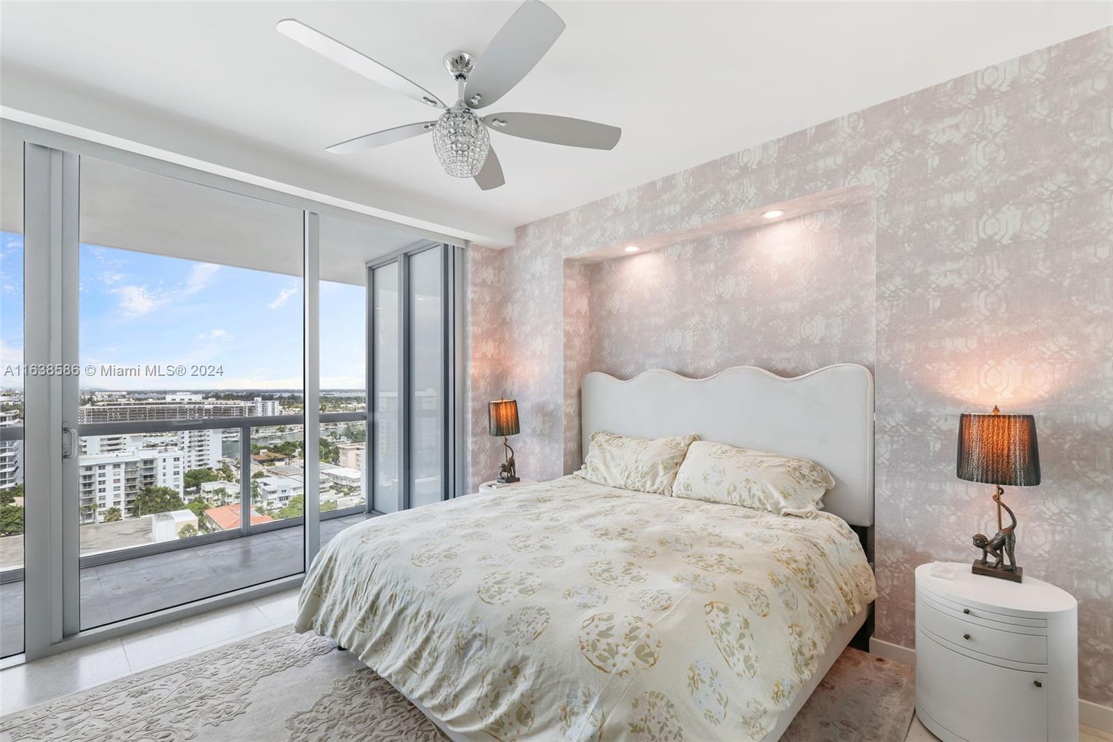 6799 Collins Avenue, Unit 1601 Miami Beach, FL 33141 - Photo 18 of 64 a bedroom with a large bed and a large window