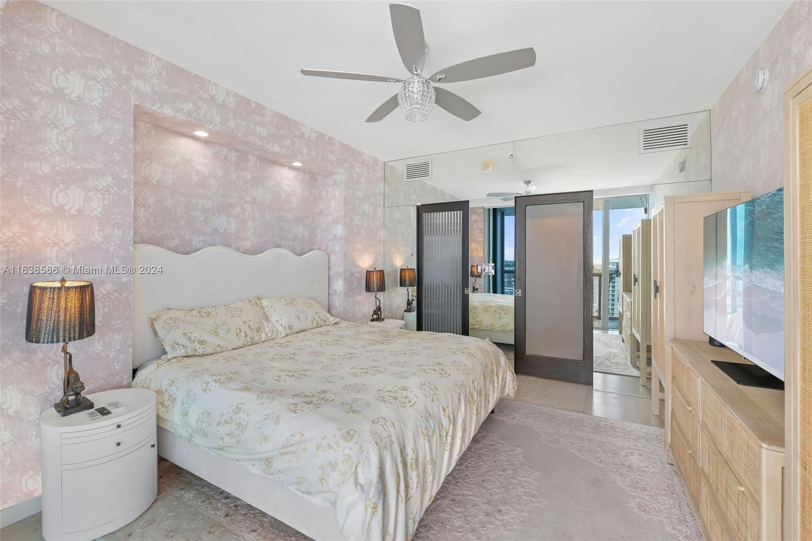 6799 Collins Avenue, Unit 1601 Miami Beach, FL 33141 - Photo 20 of 64 a spacious bedroom with a bed and a walk in closet