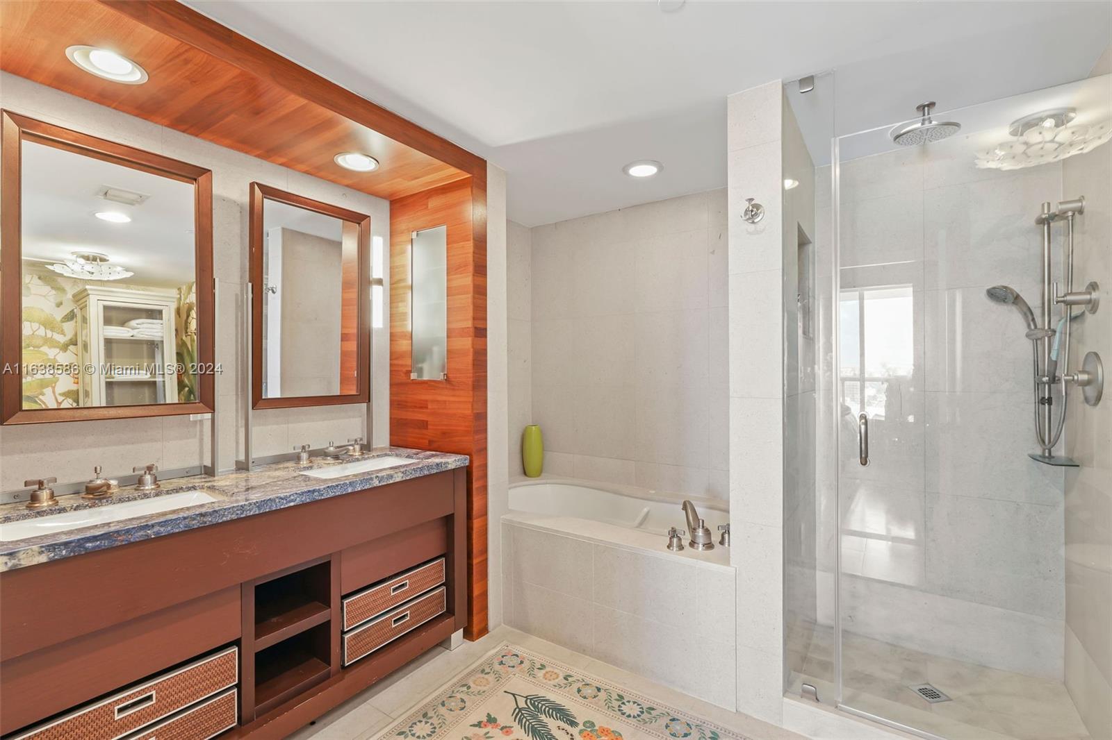 6799 Collins Avenue, Unit 1601 Miami Beach, FL 33141 - Photo 22 of 64 a bathroom with a double vanity sink mirror double and shower