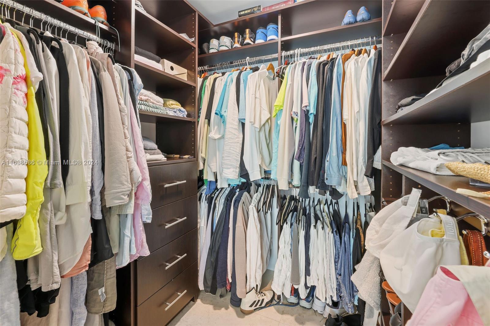 6799 Collins Avenue, Unit 1601 Miami Beach, FL 33141 - Photo 25 of 64 a view of walk in closet with clothes and shoes