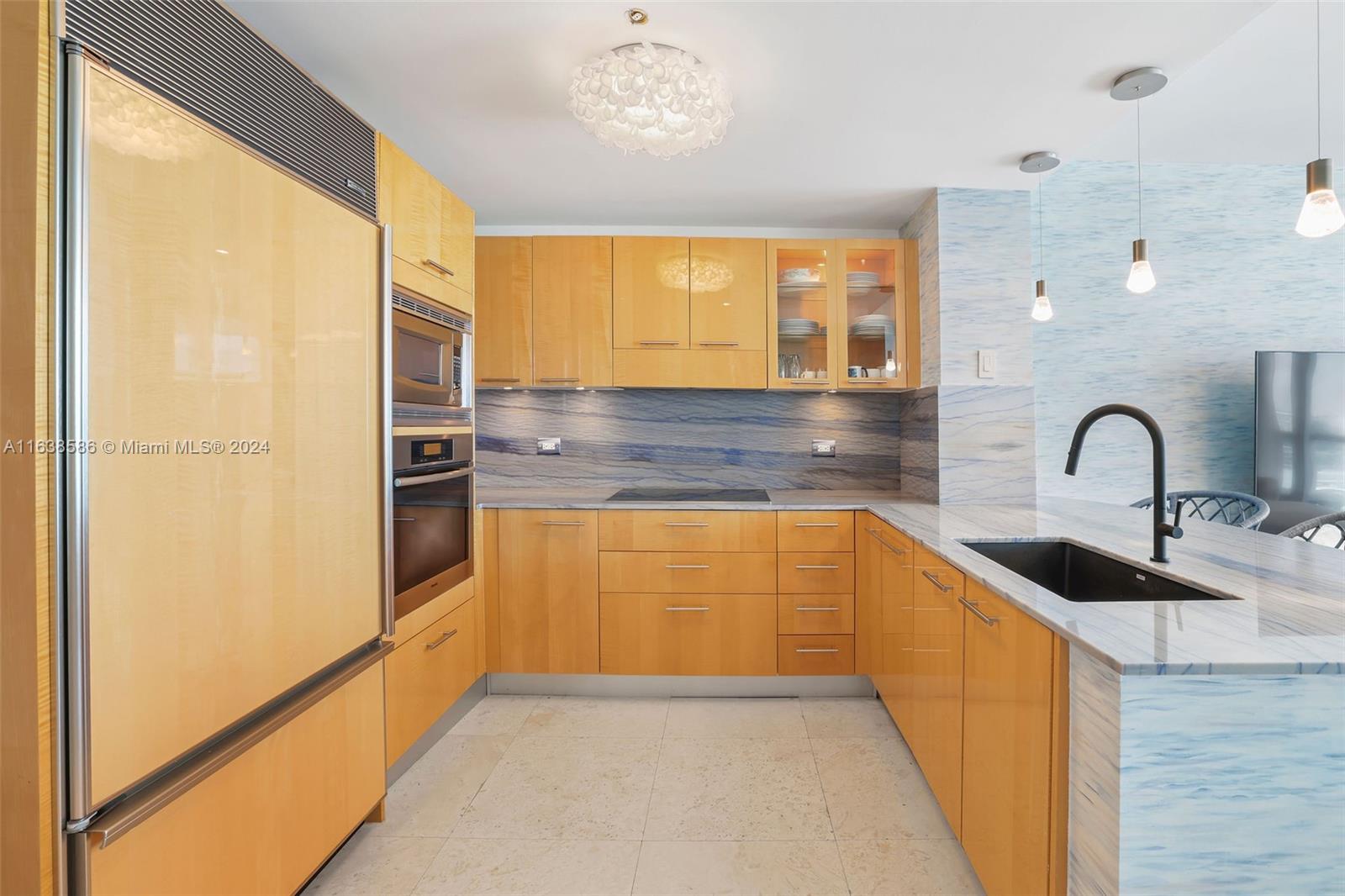 6799 Collins Avenue, Unit 1601 Miami Beach, FL 33141 - Photo 3 of 64 a kitchen with stainless steel appliances a sink and a refrigerator