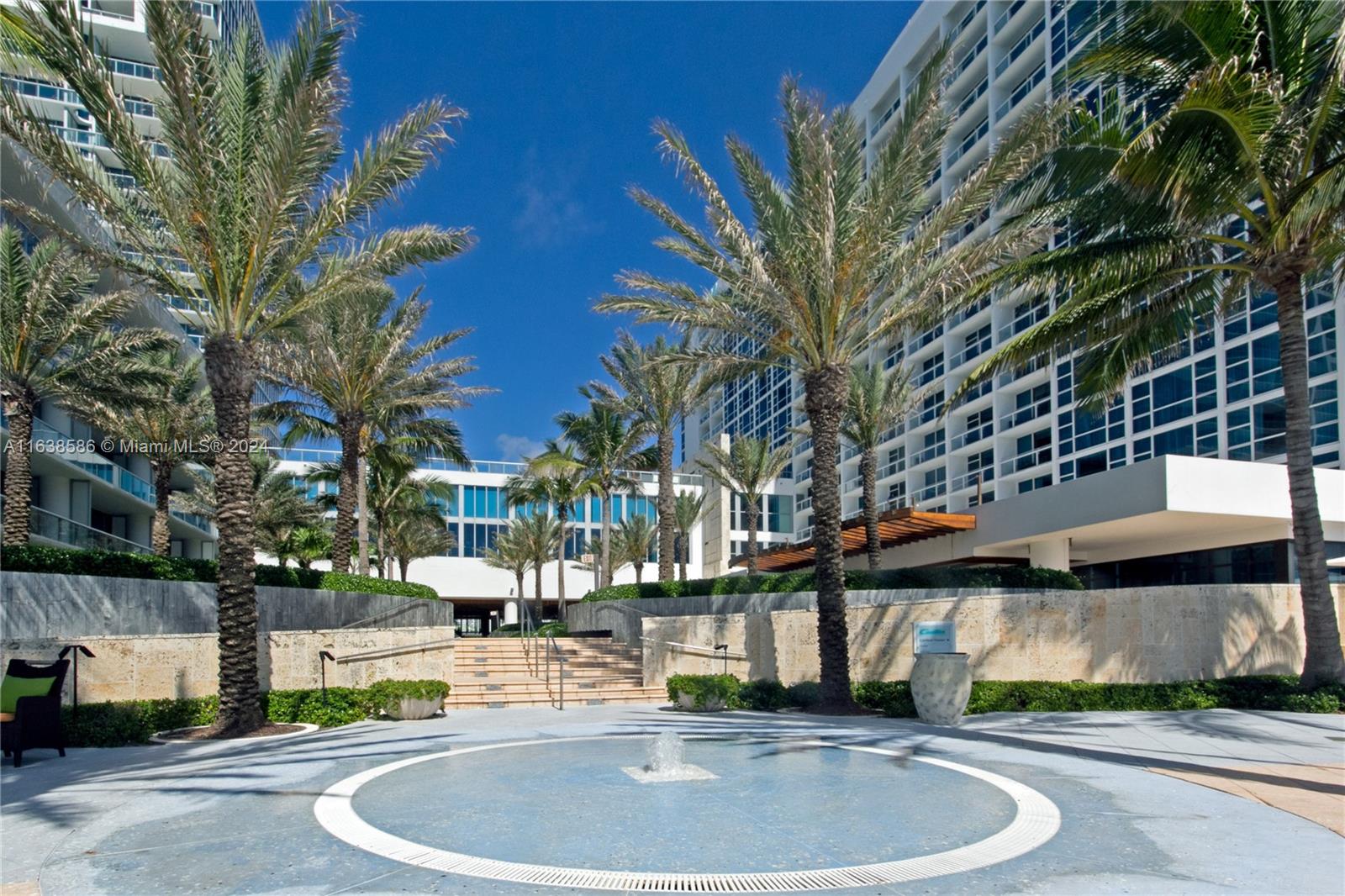 6799 Collins Avenue, Unit 1601 Miami Beach, FL 33141 - Photo 33 of 64 a swimming pool with outdoor seating and yard