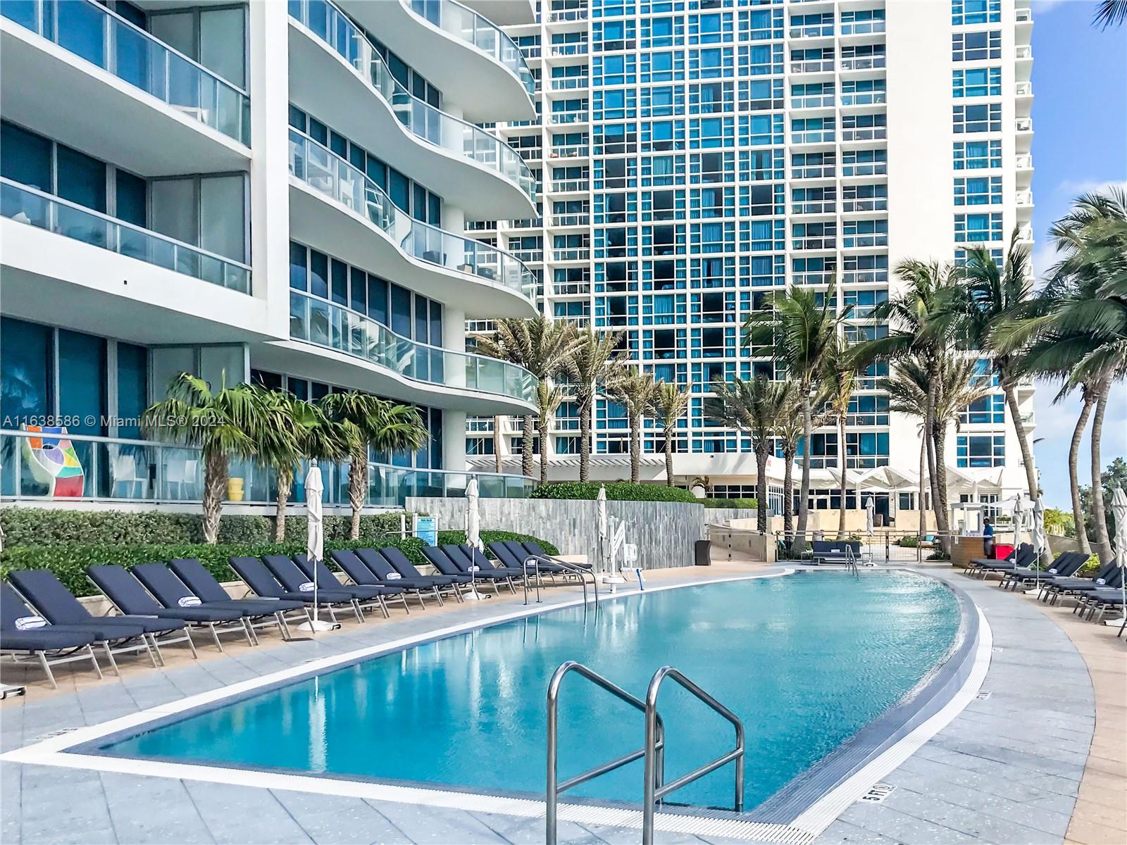 6799 Collins Avenue, Unit 1601 Miami Beach, FL 33141 - Photo 38 of 64 a view of a swimming pool with a patio