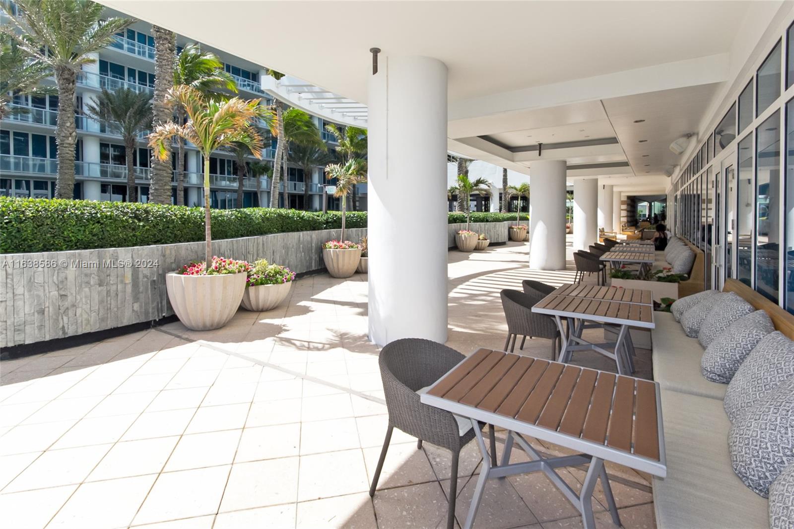 6799 Collins Avenue, Unit 1601 Miami Beach, FL 33141 - Photo 50 of 64 a view of a patio with couches table and chairs and potted plants