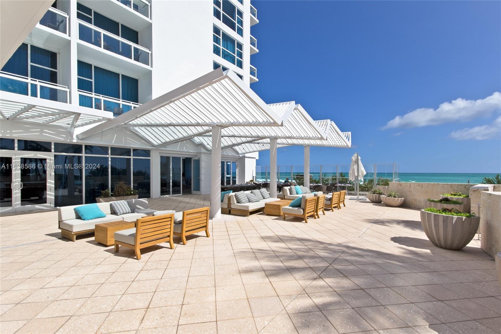 6799 Collins Avenue, Unit 1601 Miami Beach, FL 33141 - Photo 52 of 64 a view of a lounge chairs in the patio