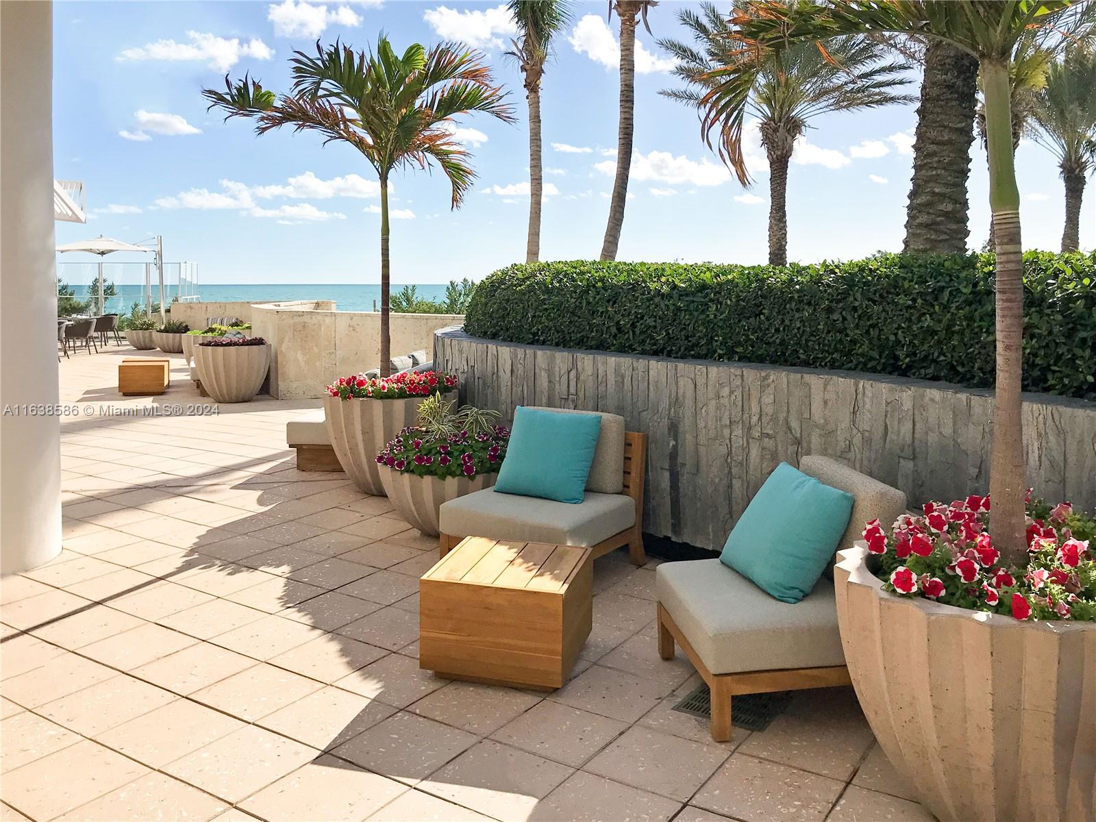 6799 Collins Avenue, Unit 1601 Miami Beach, FL 33141 - Photo 54 of 64 a view of a patio with couches and potted plants