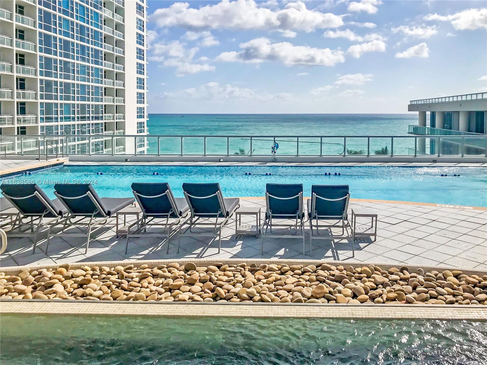6799 Collins Avenue, Unit 1601 Miami Beach, FL 33141 - Photo 57 of 64 a view of swimming pool with outdoor seating and plants