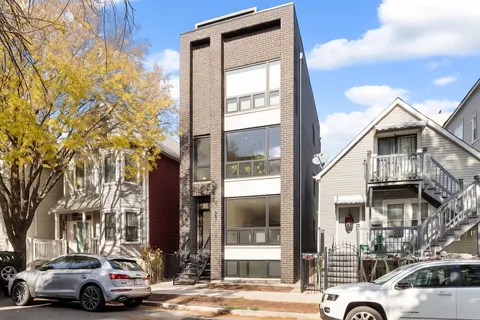a view of a cars park in front of a building