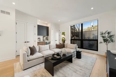 a living room with furniture and a glass door
