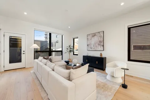 a living room with furniture a large window and a flat screen tv