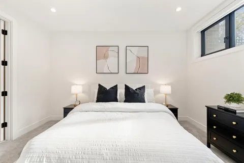 a bedroom with a bed and a night stand