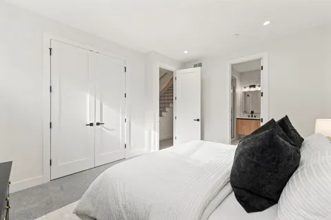 a bedroom with a bed and a mirror