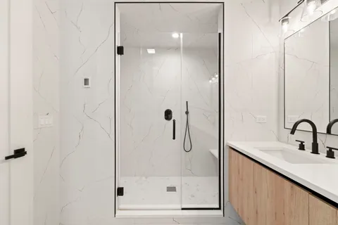 a bathroom with a shower and a sink