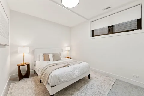 a bedroom with a bed and a night stand