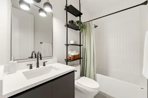 a bathroom with a sink toilet and shower