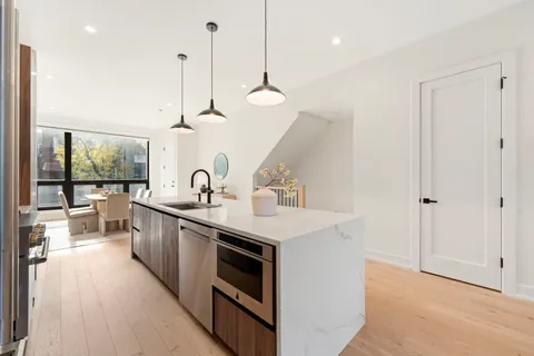a kitchen with sink stove and refrigerator