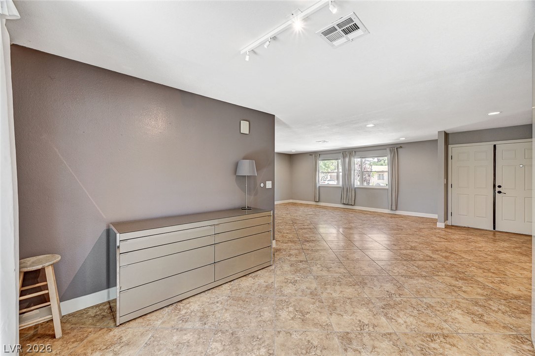 4153 Woodcrest Road Las Vegas, NV 89121 - Photo 10 of 58 A generously sized living space featuring durable tile flooring and abundant natural light.