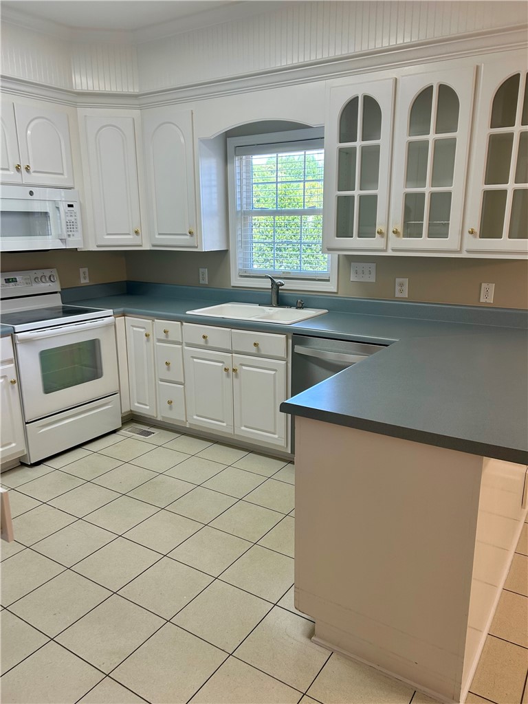 116 Buttercup Trail Anderson, SC 29621 - Photo 13 of 49 Bright and functional kitchen featuring white cabinetry and practical tile flooring.