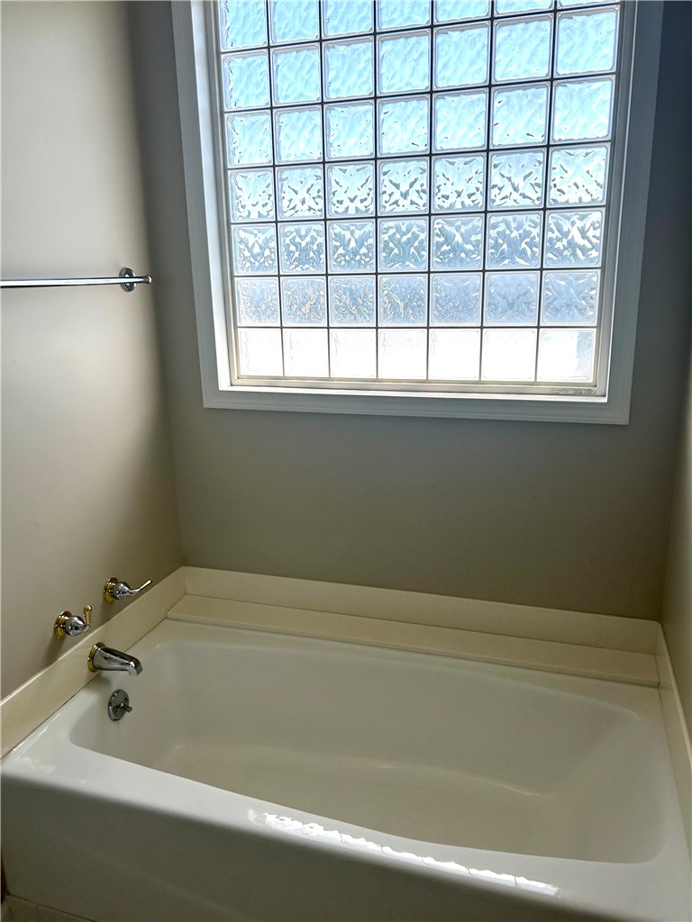 116 Buttercup Trail Anderson, SC 29621 - Photo 22 of 49 This bright bathroom features a spacious bathtub and a decorative glass block window.