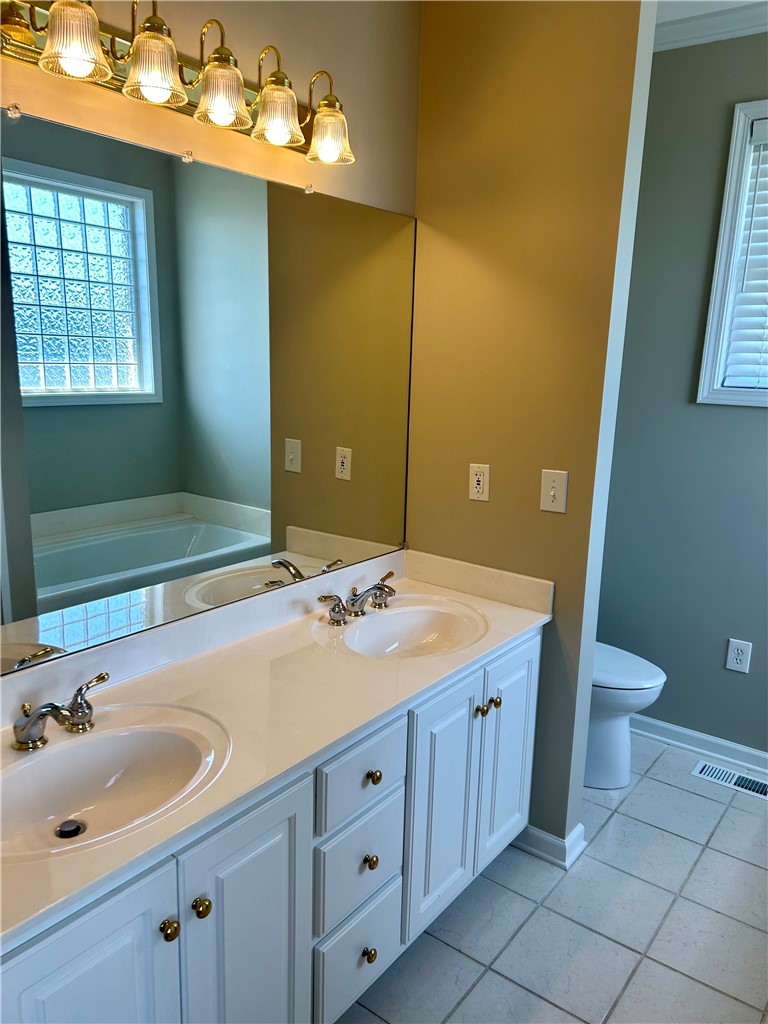 116 Buttercup Trail Anderson, SC 29621 - Photo 30 of 49 This bathroom features a double vanity and soaking tub, offering comfort and convenience.
