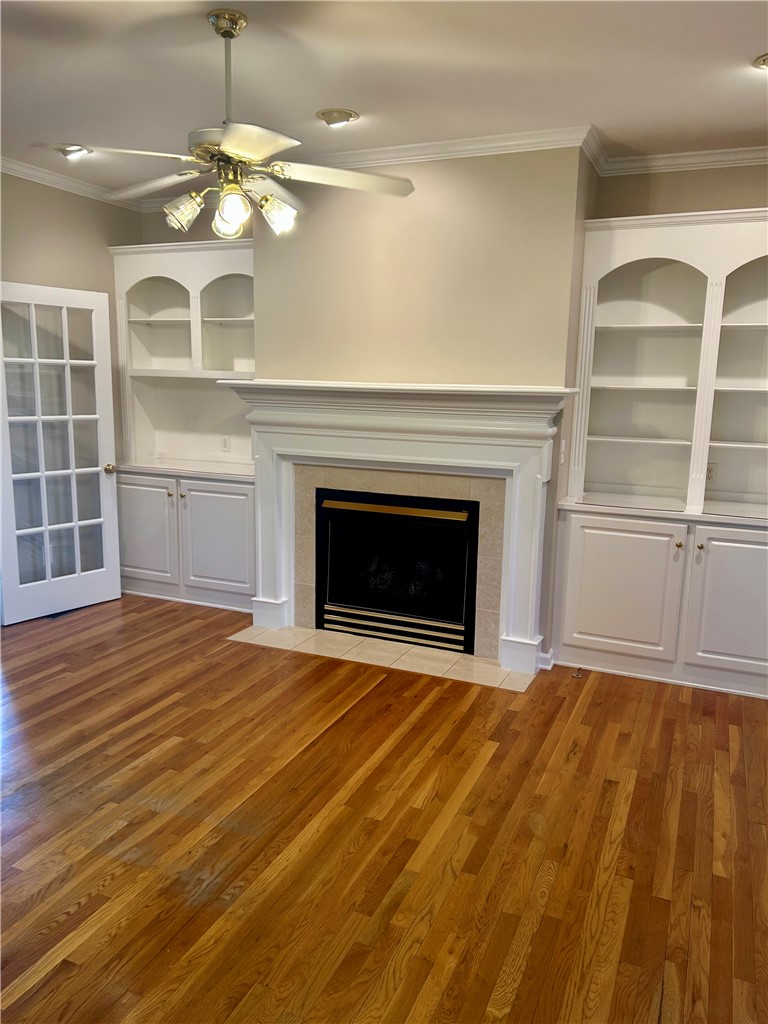 116 Buttercup Trail Anderson, SC 29621 - Photo 3 of 49 This inviting room features warm hardwood floors and a classic fireplace, creating a cozy atmosphere.