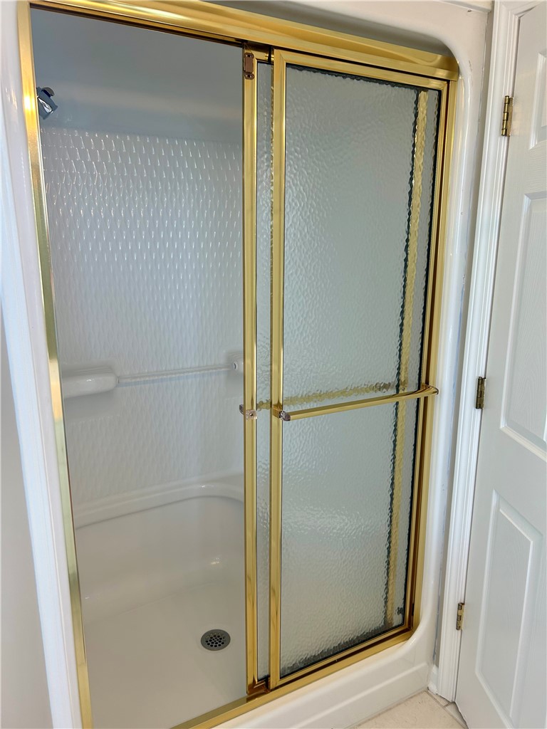 116 Buttercup Trail Anderson, SC 29621 - Photo 32 of 49 This bathroom features a sleek glass-enclosed shower with stylish gold-tone accents.
