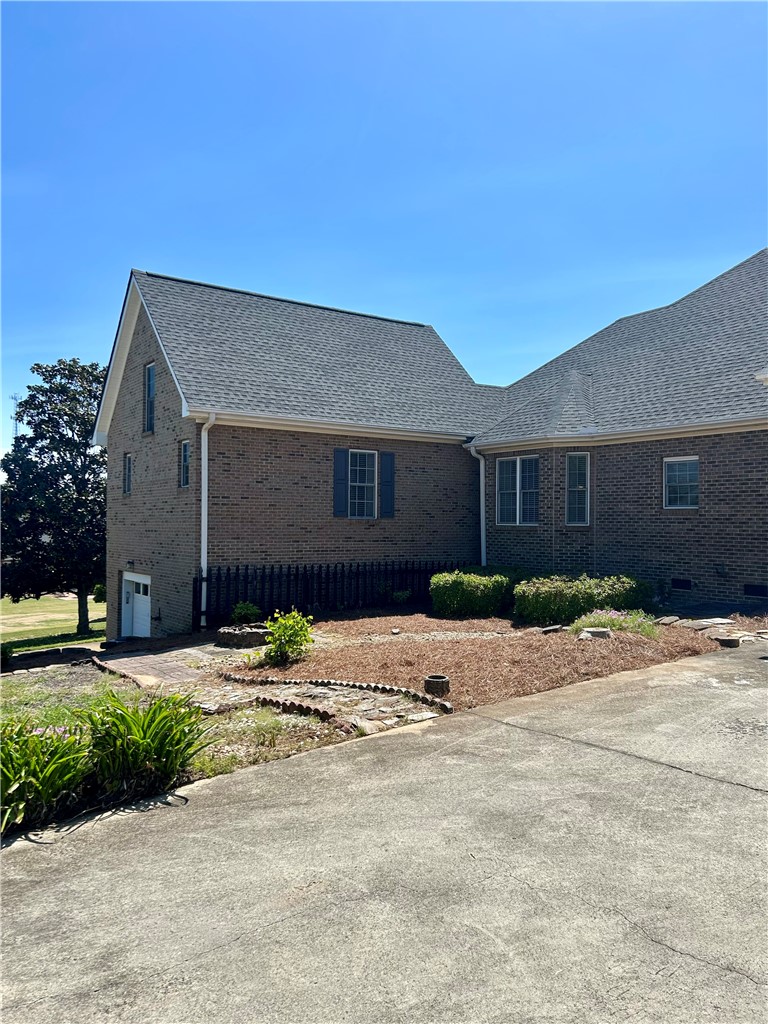 116 Buttercup Trail Anderson, SC 29621 - Photo 46 of 49 This classic brick residence features a durable shingle roof and a spacious driveway, offering ample parking.
