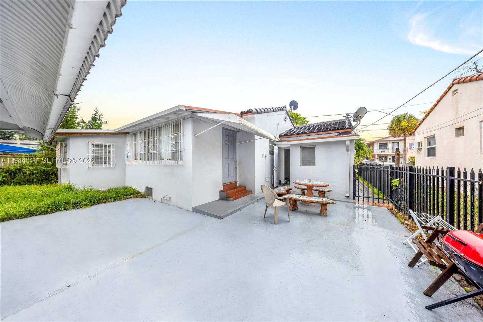 943 Southwest 9th Avenue Miami, FL 33130 - Photo 11 of 16 a view of a patio with a table and chairs under an umbrella