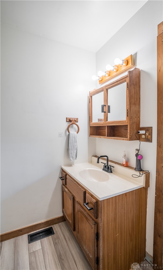 220 Racer Street Troy, OH 45373 - Photo 19 of 33 This bright bathroom features a vanity with ample storage and contemporary fixtures.