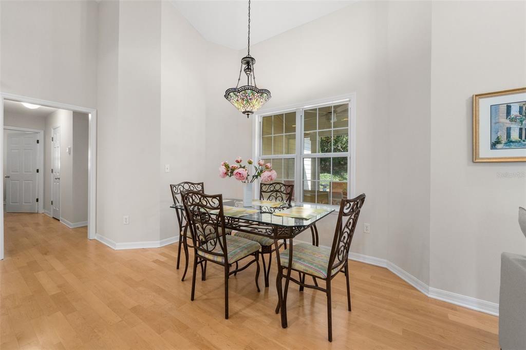 7418 White Oaks Road Alachua, FL 32615 - Photo 14 of 46 a dining room with furniture wooden floor and a chandelier