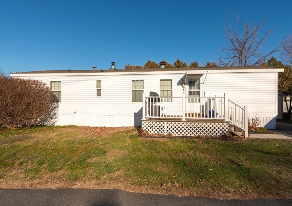 11 Groton School Road, Unit 2 Ayer, MA 01432 - Photo 1 of 14 a front view of a house with a yard