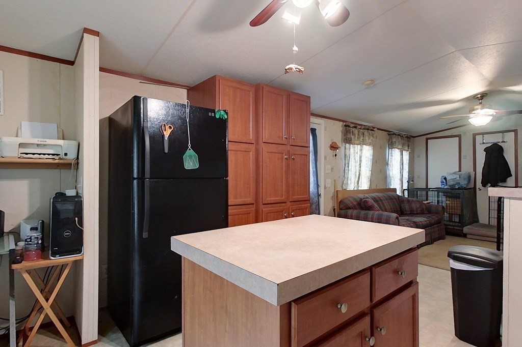 11 Groton School Road, Unit 2 Ayer, MA 01432 - Photo 5 of 14 a kitchen with stainless steel appliances a refrigerator sink and wooden cabinets