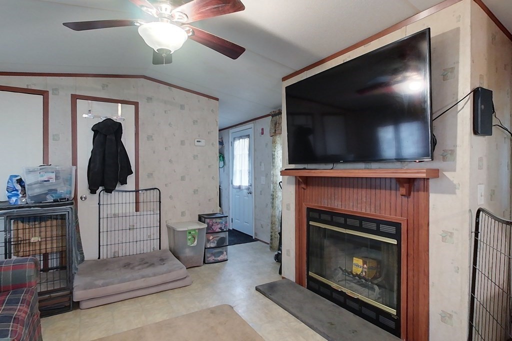 11 Groton School Road, Unit 2 Ayer, MA 01432 - Photo 6 of 14 a living room with furniture a flat screen tv and a fireplace